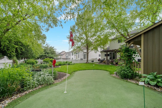 670 Mill Wood Blvd, Marysville, OH 43040 - view of yard featuring an area to practice putting, fence, and a pergola