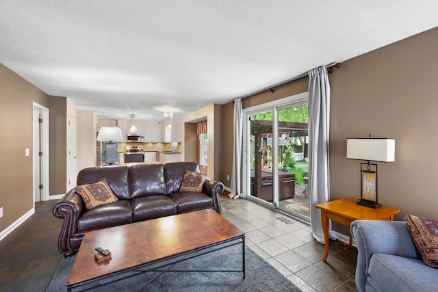 670 Mill Wood Blvd, Marysville, OH 43040 - tiled living room with a textured ceiling and baseboards