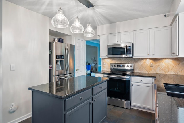 670 Mill Wood Blvd, Marysville, OH 43040 - kitchen with stainless steel appliances, white cabinetry, dark stone countertops, decorative backsplash, and a kitchen island