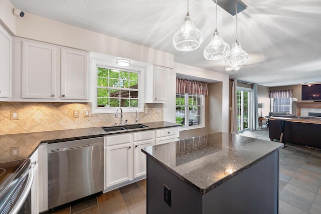 670 Mill Wood Blvd, Marysville, OH 43040 - kitchen featuring appliances with stainless steel finishes, a sink, open floor plan, tasteful backsplash, and white cabinets