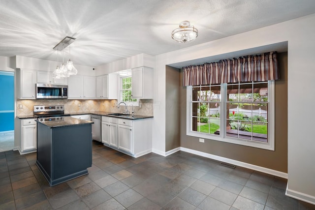670 Mill Wood Blvd, Marysville, OH 43040 - kitchen with stainless steel appliances, a chandelier, a sink, and baseboards