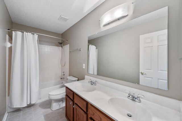 670 Mill Wood Blvd, Marysville, OH 43040 - bathroom featuring toilet, shower / tub combo, double vanity, tile patterned flooring, and a textured ceiling