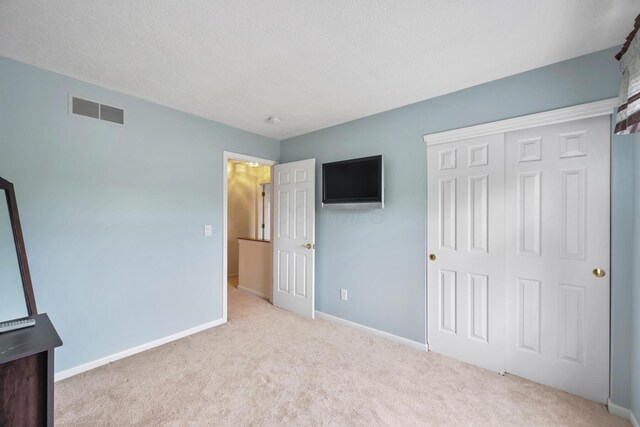 670 Mill Wood Blvd, Marysville, OH 43040 - unfurnished bedroom with carpet, a closet, baseboards, and a textured ceiling