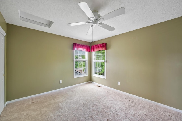 670 Mill Wood Blvd, Marysville, OH 43040 - carpeted spare room with attic access, a textured ceiling, a ceiling fan, and baseboards