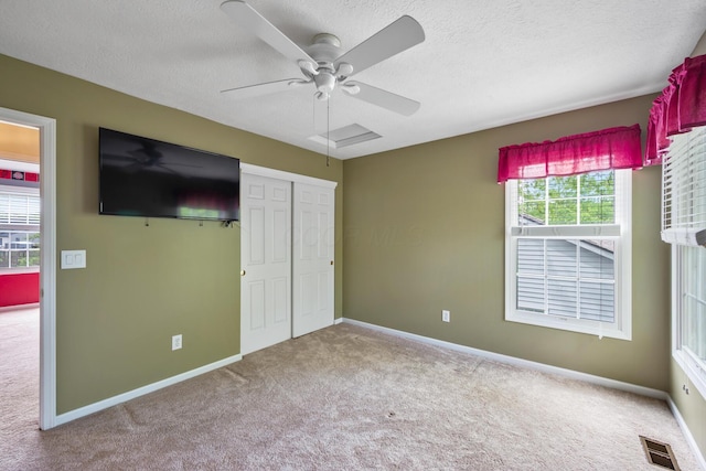 670 Mill Wood Blvd, Marysville, OH 43040 - unfurnished bedroom with carpet flooring, baseboards, a textured ceiling, a closet, and ceiling fan