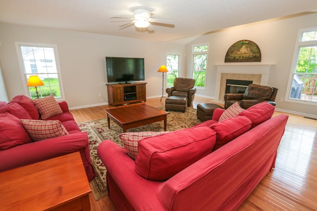 7553 Indian Creek Way, Powell, OH 43065 - living room featuring a fireplace, plenty of natural light, wood finished floors, and ceiling fan