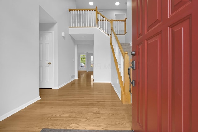 7553 Indian Creek Way, Powell, OH 43065 - entrance foyer with stairway, light wood-style floors, recessed lighting, and a towering ceiling
