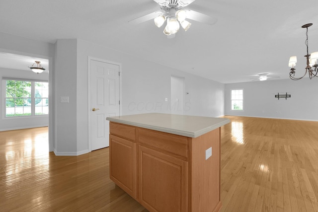 7553 Indian Creek Way, Powell, OH 43065 - kitchen with a ceiling fan, light wood-type flooring, open floor plan, and a chandelier