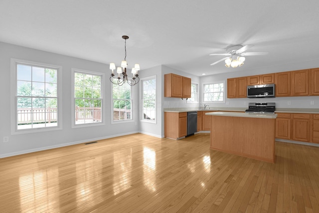7553 Indian Creek Way, Powell, OH 43065 - kitchen with stainless steel appliances, light countertops, a chandelier, light wood finished floors, and a kitchen island