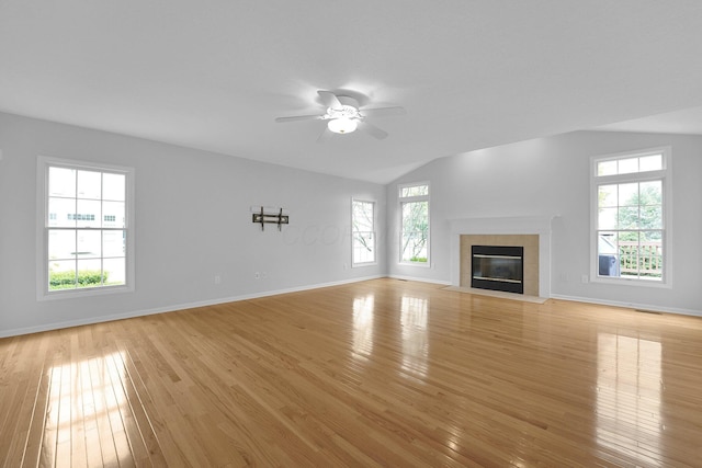 7553 Indian Creek Way, Powell, OH 43065 - unfurnished living room with light wood-style flooring, ceiling fan, vaulted ceiling, and a tile fireplace