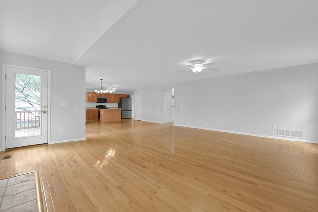7553 Indian Creek Way, Powell, OH 43065 - unfurnished living room with a chandelier, light wood-style flooring, and a ceiling fan