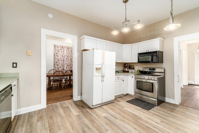 626 Evans St, Newark, OH 43055 - kitchen featuring appliances with stainless steel finishes, light wood-style floors, light countertops, and white cabinets