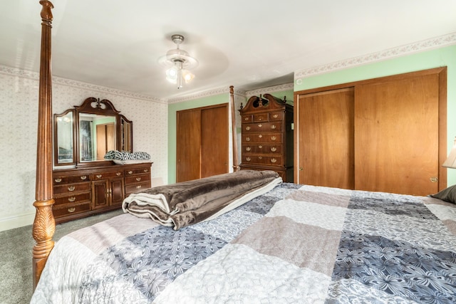 626 Evans St, Newark, OH 43055 - bedroom with multiple closets, wallpapered walls, carpet flooring, and a ceiling fan