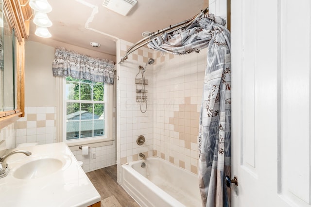 626 Evans St, Newark, OH 43055 - full bathroom featuring shower / bath combination with curtain, tile walls, wood finished floors, and vanity