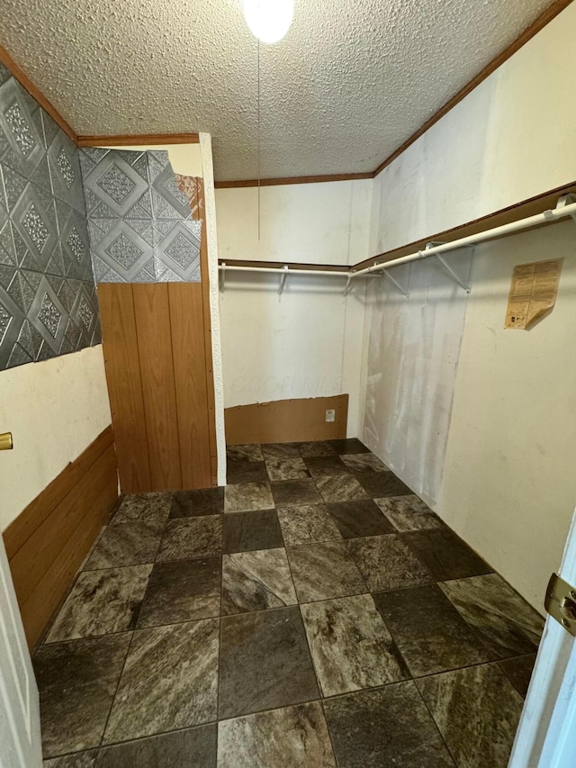 spacious closet featuring stone finish floor