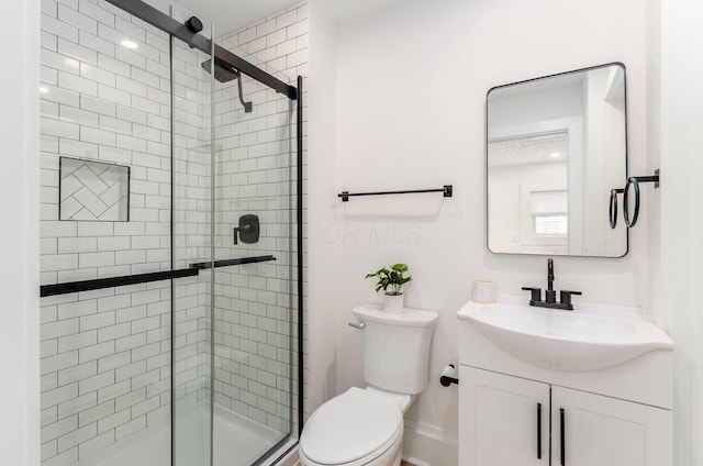 full bathroom featuring vanity, toilet, and a shower stall