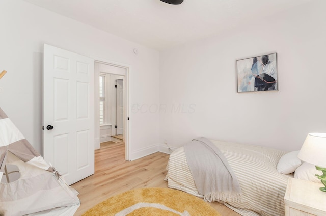 bedroom with baseboards and light wood-style flooring