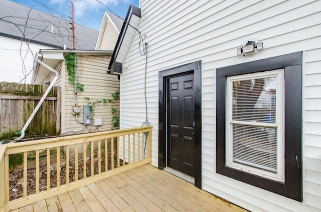 property entrance with a deck and fence