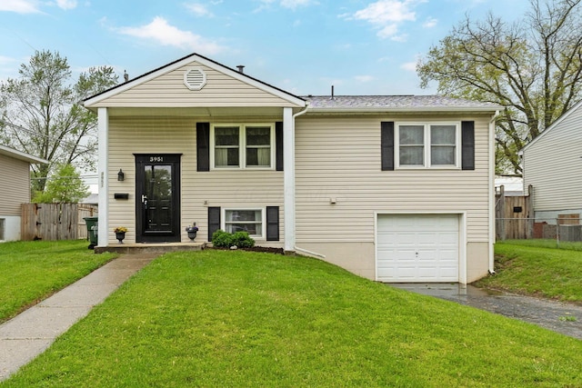3951 Ivorton Rd W, Columbus, OH 43207 - view of front of home featuring aphalt driveway, fence, a garage, and a front lawn