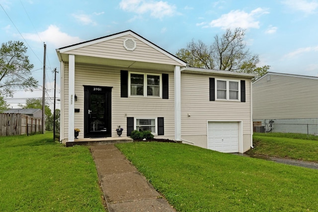 3951 Ivorton Rd W, Columbus, OH 43207 - view of front of home with an attached garage, driveway, fence, and a front yard