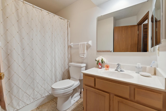 bathroom featuring toilet, vanity, and curtained shower