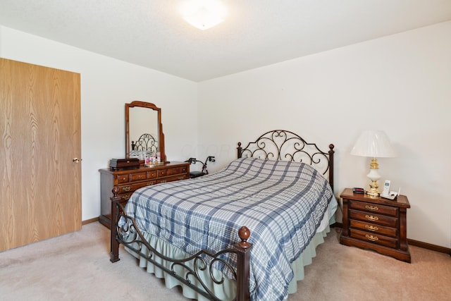 carpeted bedroom with baseboards