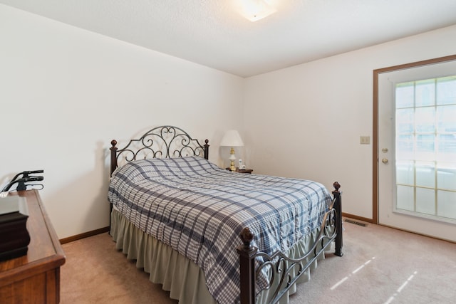 carpeted bedroom with visible vents and baseboards