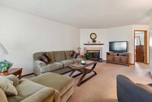 living area featuring light carpet, a fireplace, and baseboards