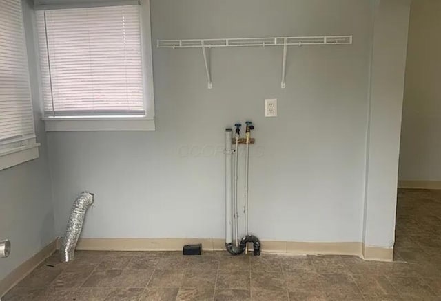 washroom featuring baseboards and laundry area