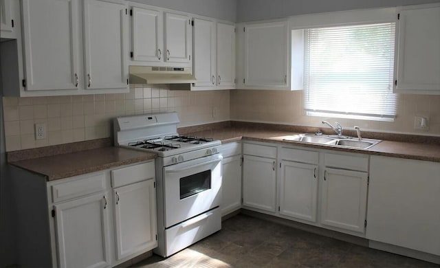 kitchen featuring white cabinetry, under cabinet range hood, gas range gas stove, and a sink