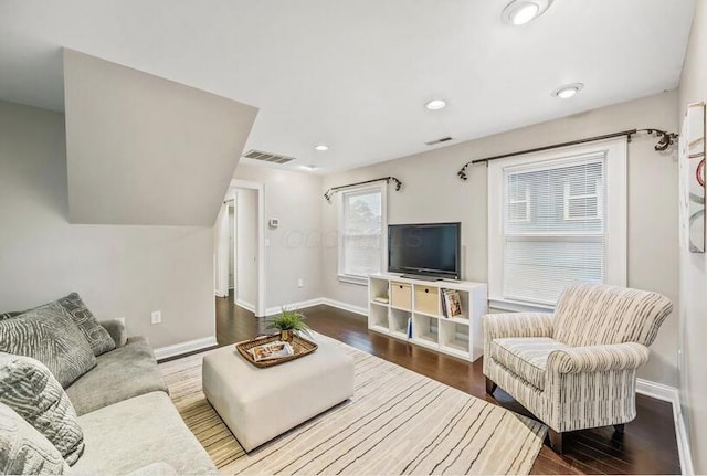 living area with recessed lighting, baseboards, visible vents, and wood finished floors