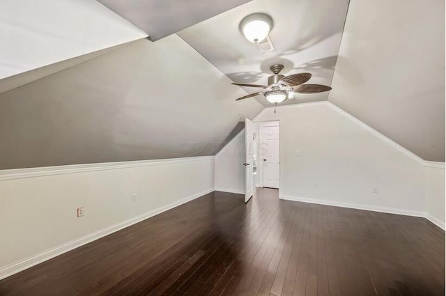 bonus room with baseboards, dark wood-style flooring, ceiling fan, and vaulted ceiling