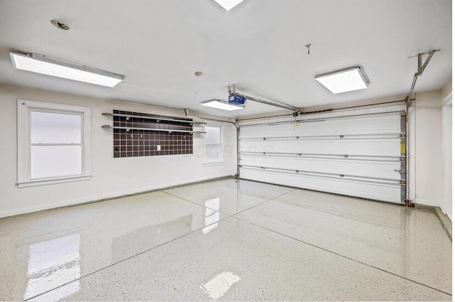 garage featuring baseboards and a garage door opener