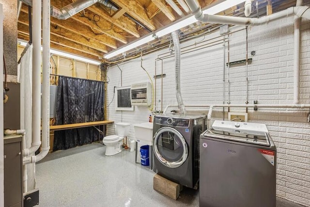 clothes washing area with laundry area and washer and dryer