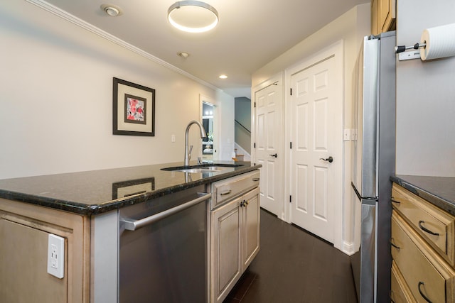 1225 Eastview Ave, Columbus, OH 43212 - kitchen featuring a sink, appliances with stainless steel finishes, crown molding, dark stone countertops, and a center island with sink