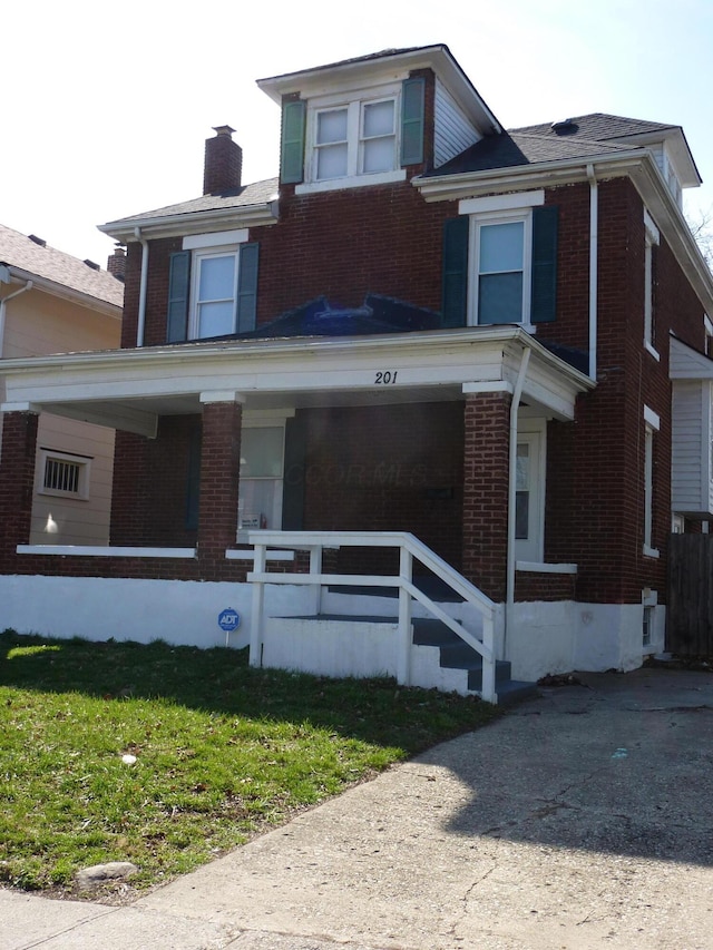 201 N Warren Ave, Columbus, OH 43204 - american foursquare style home featuring a chimney, a front lawn, brick siding, and covered porch