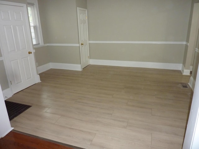 201 N Warren Ave, Columbus, OH 43204 - foyer entrance with light wood finished floors, visible vents, and baseboards