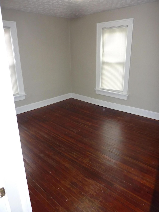 201 N Warren Ave, Columbus, OH 43204 - spare room with baseboards and dark wood-style floors