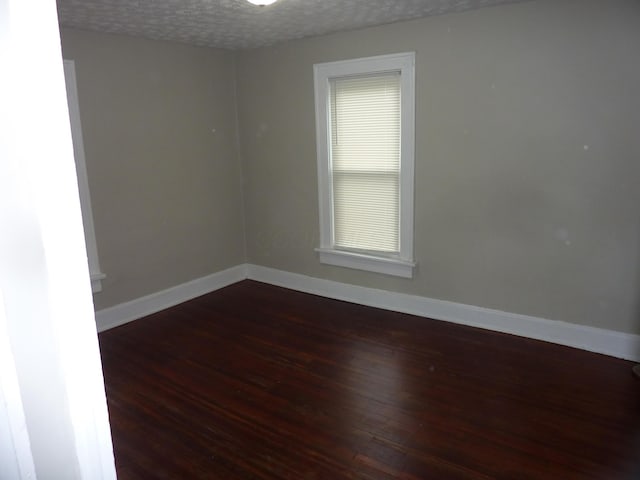 201 N Warren Ave, Columbus, OH 43204 - empty room with a textured ceiling, baseboards, and wood-type flooring