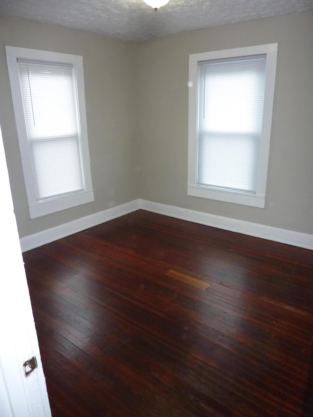 201 N Warren Ave, Columbus, OH 43204 - empty room featuring baseboards, wood-type flooring, and a textured ceiling