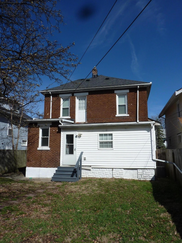 201 N Warren Ave, Columbus, OH 43204 - rear view of property with brick siding, fence, a lawn, and entry steps