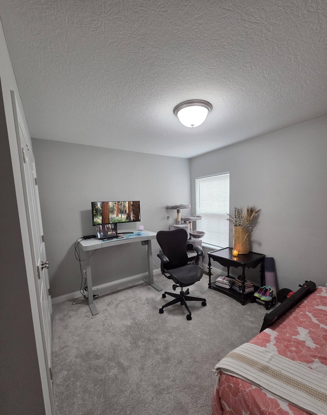 bedroom featuring a textured ceiling and carpet floors