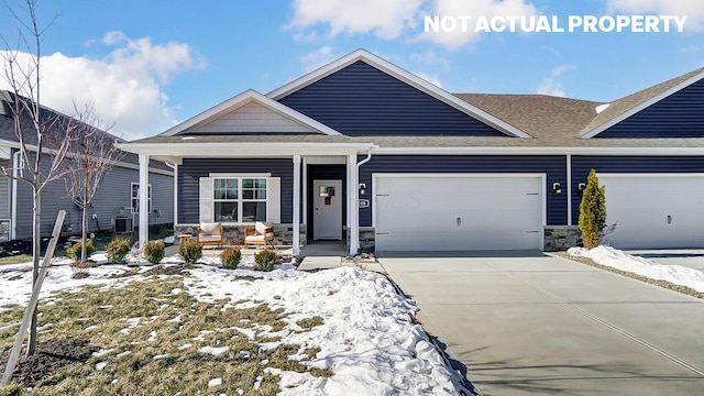 view of front facade featuring driveway, an attached garage, a shingled roof, stone siding, and a porch