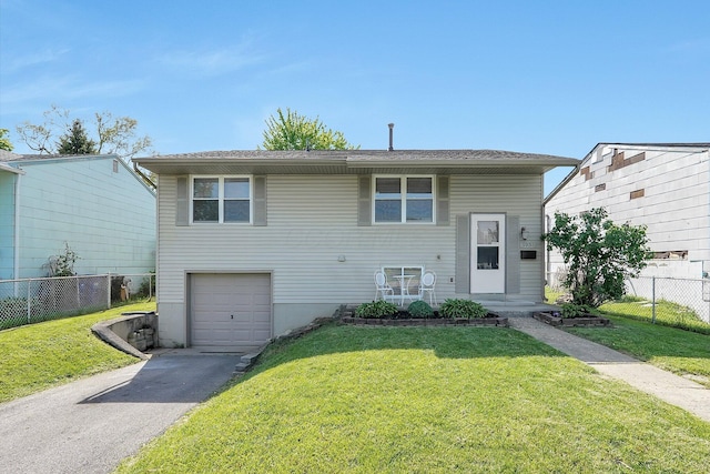 3935 Hillman Rd W, Columbus, OH 43207 - view of front of home with a front lawn, fence, a garage, and aphalt driveway