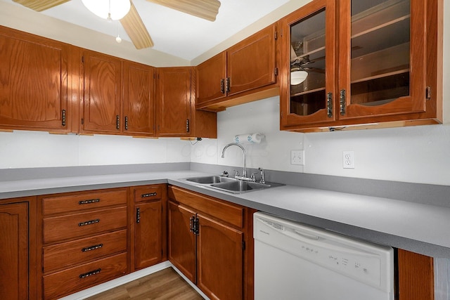3935 Hillman Rd W, Columbus, OH 43207 - kitchen with a sink, brown cabinetry, dishwasher, a ceiling fan, and glass insert cabinets