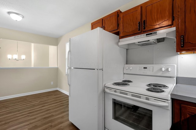 3935 Hillman Rd W, Columbus, OH 43207 - kitchen featuring brown cabinetry, dark wood-style flooring, baseboards, white appliances, and under cabinet range hood