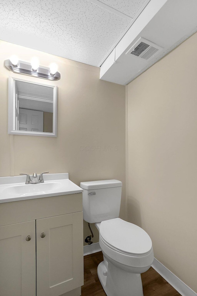 3935 Hillman Rd W, Columbus, OH 43207 - half bath with toilet, visible vents, wood finished floors, and baseboards