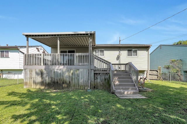 3935 Hillman Rd W, Columbus, OH 43207 - rear view of property featuring a lawn, stairway, a wooden deck, and fence