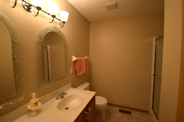bathroom with an enclosed shower, toilet, visible vents, and vanity