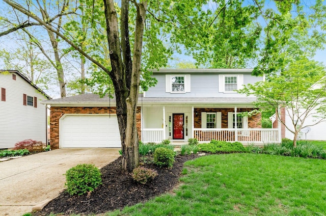 traditional-style home with brick siding, a garage, concrete driveway, a front yard, and a porch